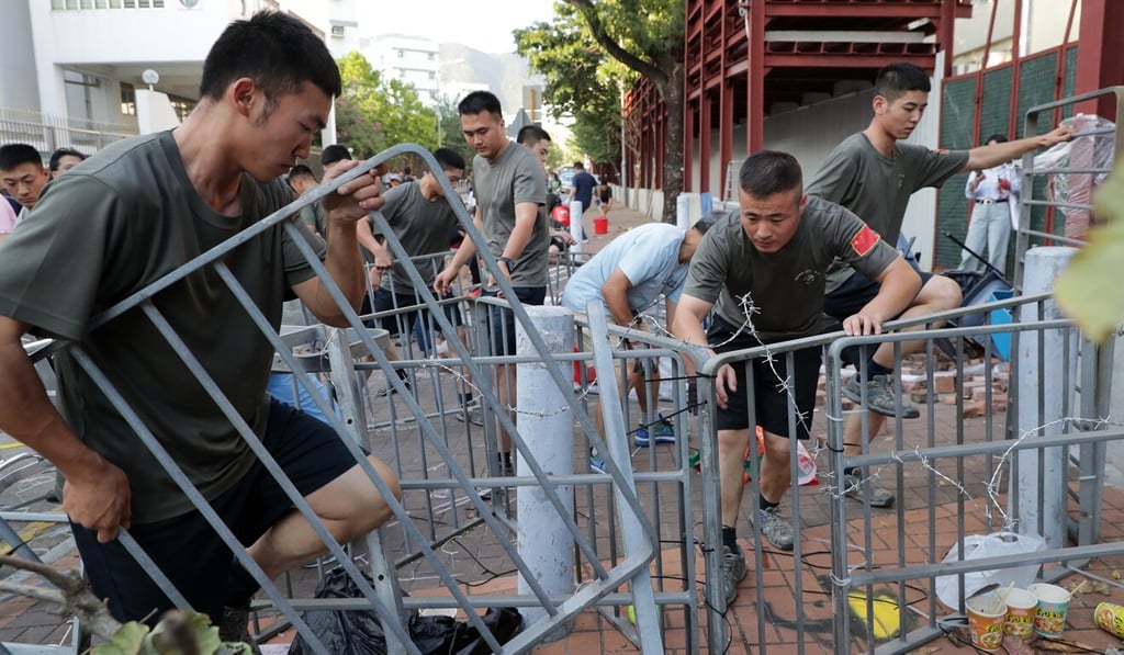 Soldiers from the People’s Liberation Army help clear roadblocks in Kowloon Tong in November last year. Photo: Edmond So Soldiers from the People’s Liberation Army help clear roadblocks in Kowloon Tong in November last year. Photo: Edmond So
