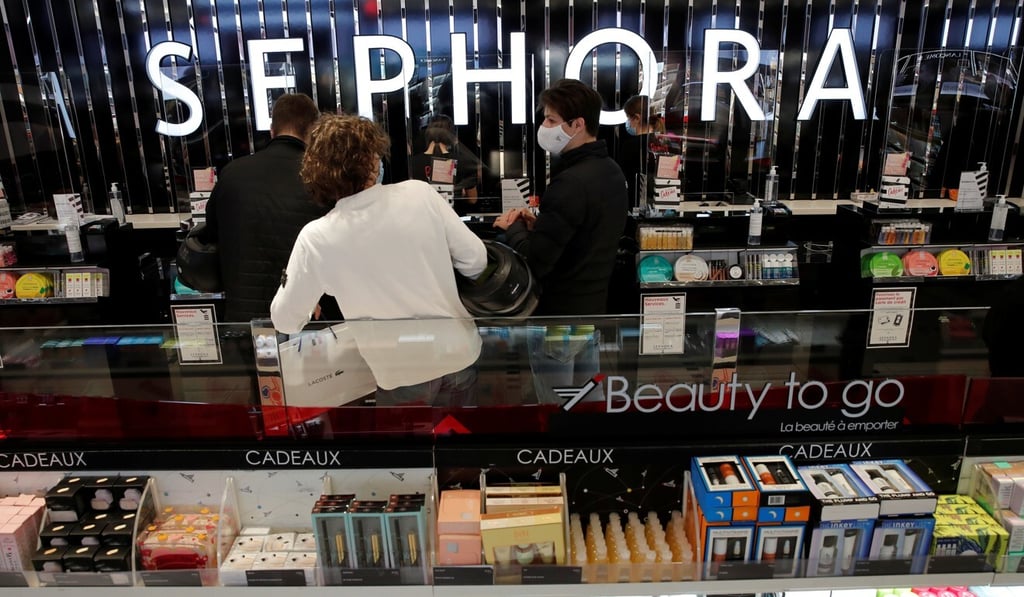 Customers wear face masks at a Sephora store in Paris. Demand for lipstick has dropped. Photo: Reuters