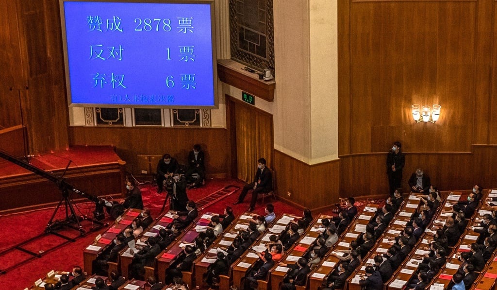 Delegates applaud as the result of a vote on the draft resolution for the controversial national security law for Hong Kong is displayed on a screen during the closing ceremony of the third session of the 13th National People’s Congress in Beijing. Photo: EPA-EFE Delegates applaud as the result of a vote on the draft resolution for the controversial national security law for Hong Kong is displayed on a screen during the closing ceremony of the third session of the 13th National People’s Congress in Beijing. Photo: EPA-EFE