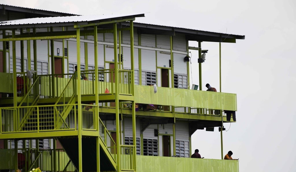 Residents stand along corridors of Tuas South Dormitory in Singapore on April 19. Photo: AFP