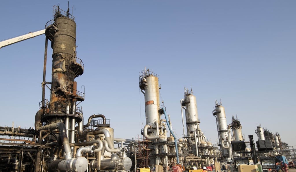 Workers repair a damaged refining tower at Saudi Aramco's Abqaiq crude oil processing plant following a drone attack in Abqaiq, Saudi Arabia, in September 2019. Photo: Bloomberg