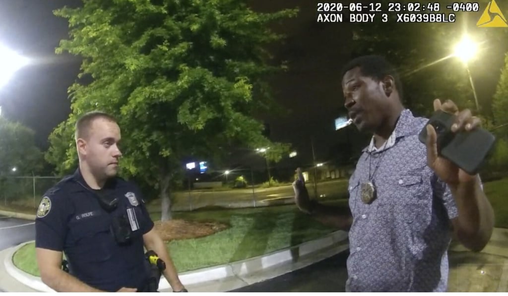 This screen grab taken from body camera video provided by the Atlanta Police Department shows Rayshard Brooks speaking with Officer Garrett Rolfe in the car park of a Wendy's restaurant on June 12. Photo: AP