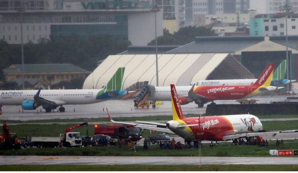 A VietJet Air passenger plane is seen on grass field after skidding at the Tan Son Nhat airport, in Ho Chi Minh City. Photo: Reuters
