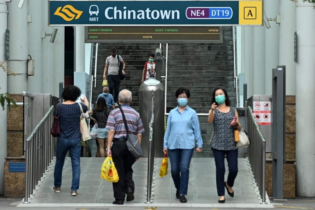 People walk in and out of the Singapore Mass Rapid Transit station in Singapore’s Chinatown district. Experts are still struggling to understand the extent of Covid-19 immunity. Photo: AFP