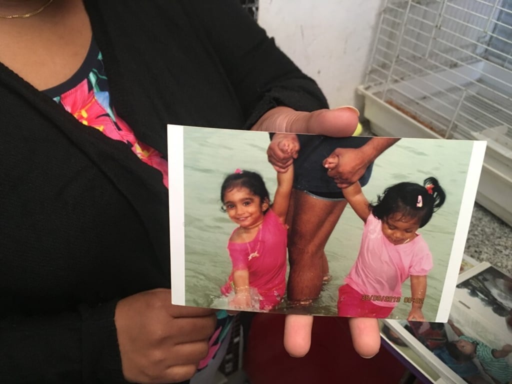 Nadeeka Dilrukshi Nonis holds a photo of her daughter Sethumdi with her half-sister Keana. Photo: Raquel Carvalho