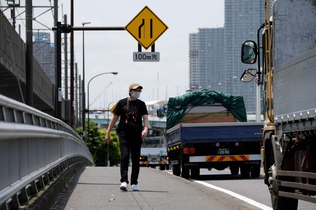 Where is the glove: Koji Ishii on the lookout for lost gloves in Tokyo. Photo: AFP Where is the glove: Koji Ishii on the lookout for lost gloves in Tokyo. Photo: AFP