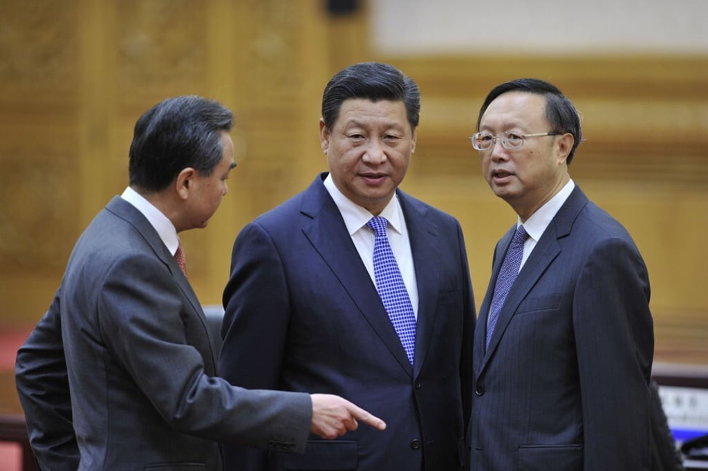 Chinese President Xi Jinping, centre, with Chinese Foreign Minister Wang Yi, left, and diplomat Yang Jiechi. Photo: Getty Images