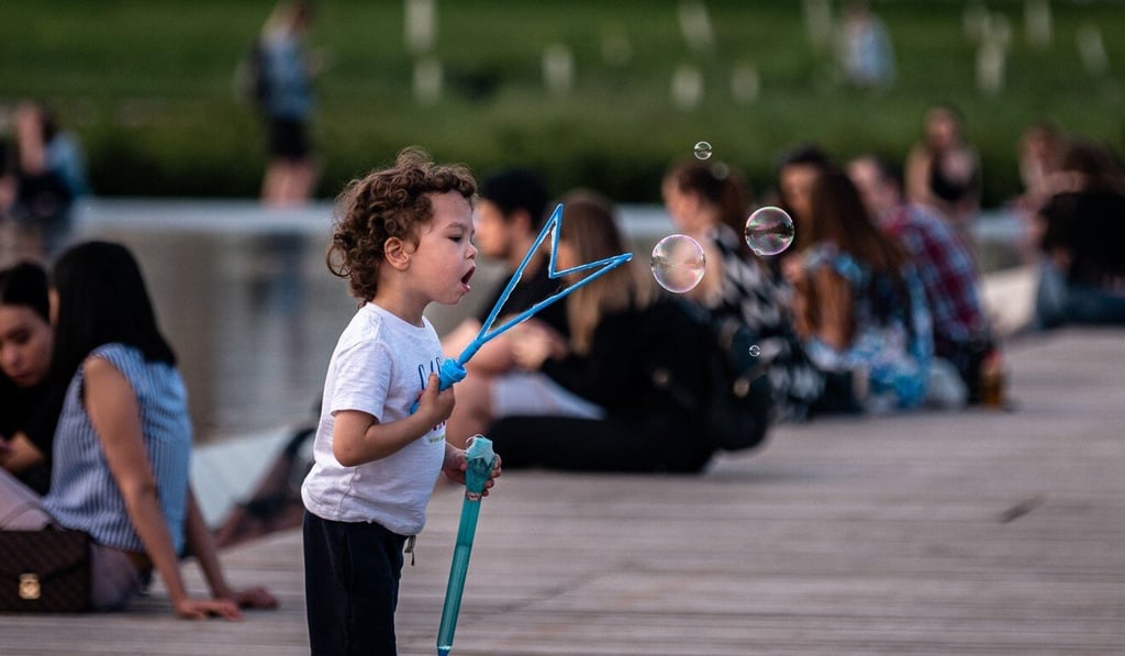 A boy makes soap bubbles at a park in Moscow. Miyako was inspired to try bubbles for plant pollination after seeing his son play with some. Photo: AFP A boy makes soap bubbles at a park in Moscow. Miyako was inspired to try bubbles for plant pollination after seeing his son play with some. Photo: AFP