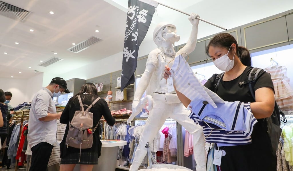 Shoppers at the Chickeeduck store at Discovery Park in Tsuen Wan look at merchandise next to the protester statue that mall management has asked be removed. Photo: Edmond So Shoppers at the Chickeeduck store at Discovery Park in Tsuen Wan look at merchandise next to the protester statue that mall management has asked be removed. Photo: Edmond So