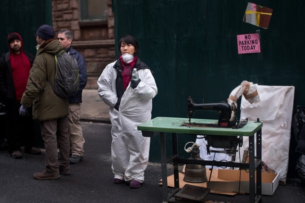Yue Ma (in protective gear), of the Museum of Chinese in America, with items recovered from the building, including a sewing machine once used in a sweatshop in New York’s Chinatown. Photo: Alan Chin