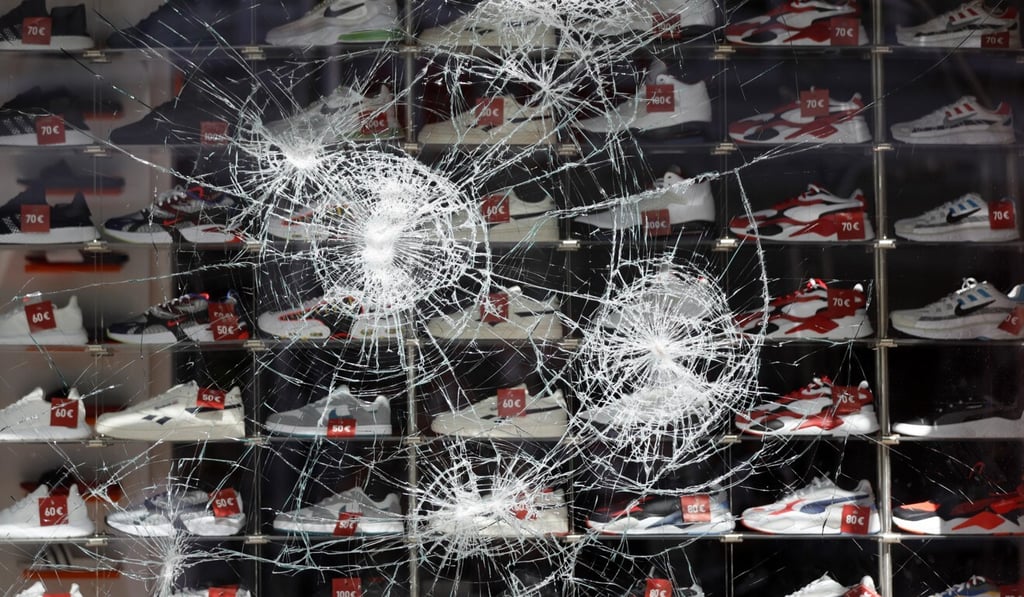 Damaged glass at a shoe store in the downtown shopping area of Stuttgart on Sunday. Photo: EPA