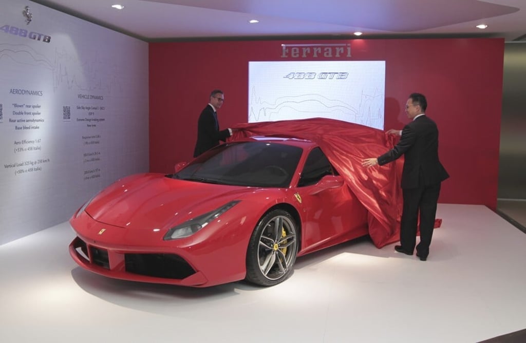 Matteo Torre (left), president and CEO of Ferrari Greater China and Benny Chong, executive chairman and CEO of Auto Italia, unveil the new Ferrari 488 GTB. Photo: SCMP