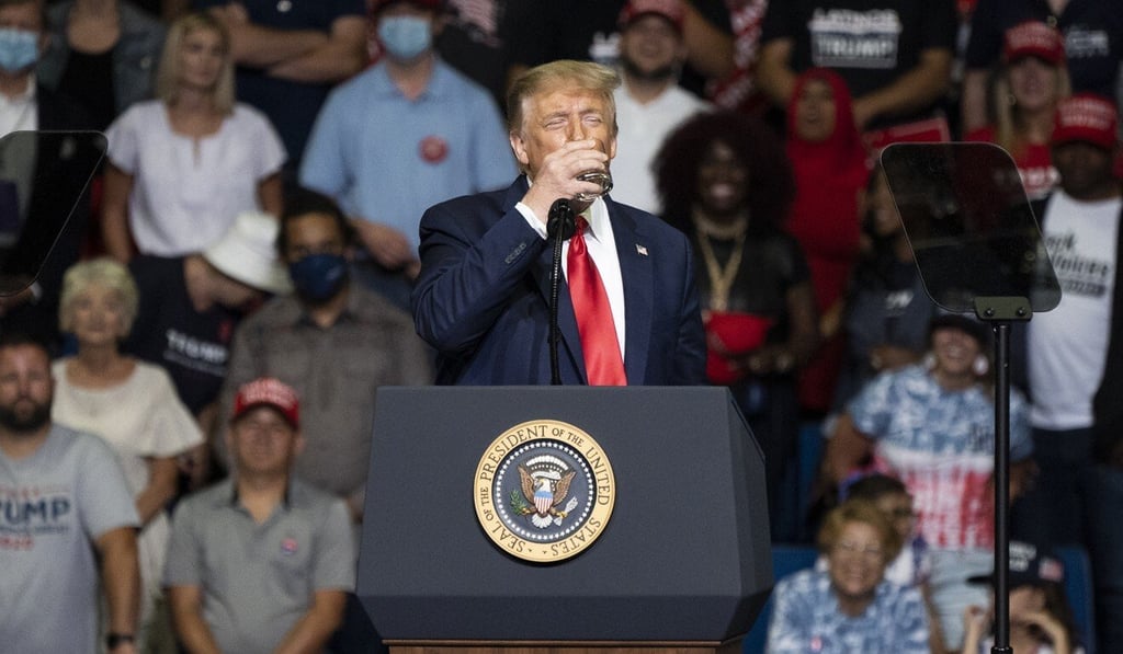 US President Donald Trump drinks from a cup of water at a rally in Tulsa on Saturday after being mocked online for having trouble lifting a glass at an earlier event. Photo: Bloomberg US President Donald Trump drinks from a cup of water at a rally in Tulsa on Saturday after being mocked online for having trouble lifting a glass at an earlier event. Photo: Bloomberg