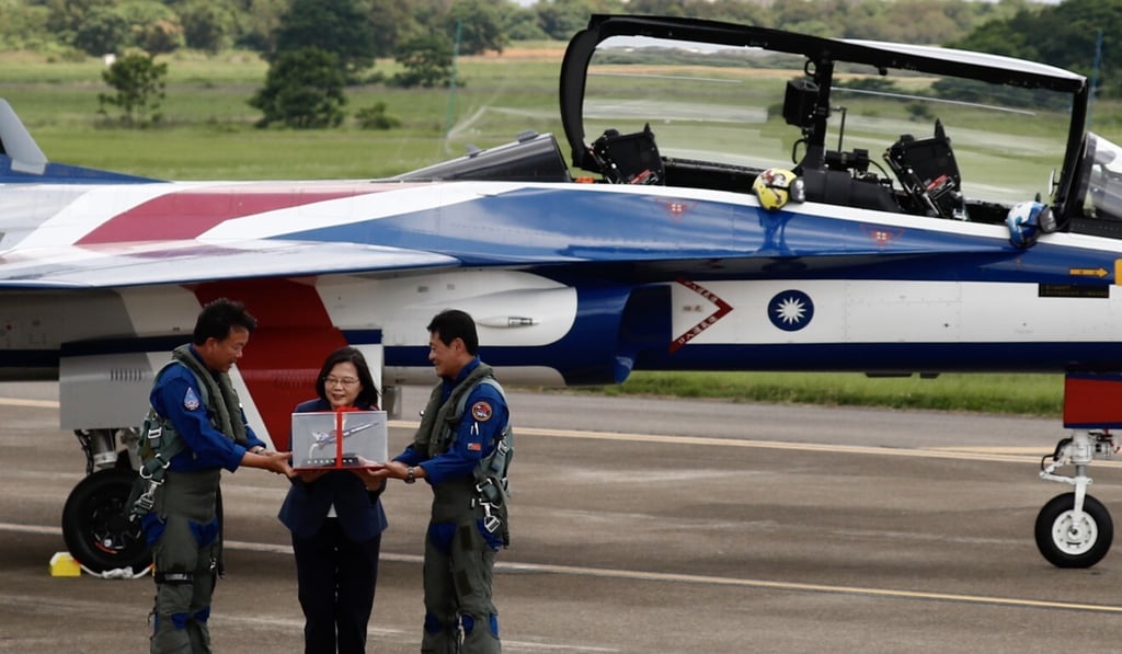 Taiwan President Tsai Ing-wen (centre) is presented with a model of the AJT Yung Yin [Brave Eagle] at a ceremony to mark its maiden flight. Photo: EPA-EFE