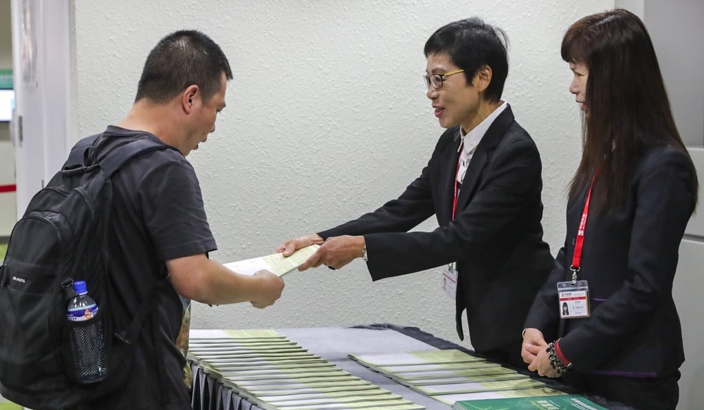 An applicant picks up a ‘green form’ during a previous offering. Photo: Edmond So An applicant picks up a ‘green form’ during a previous offering. Photo: Edmond So