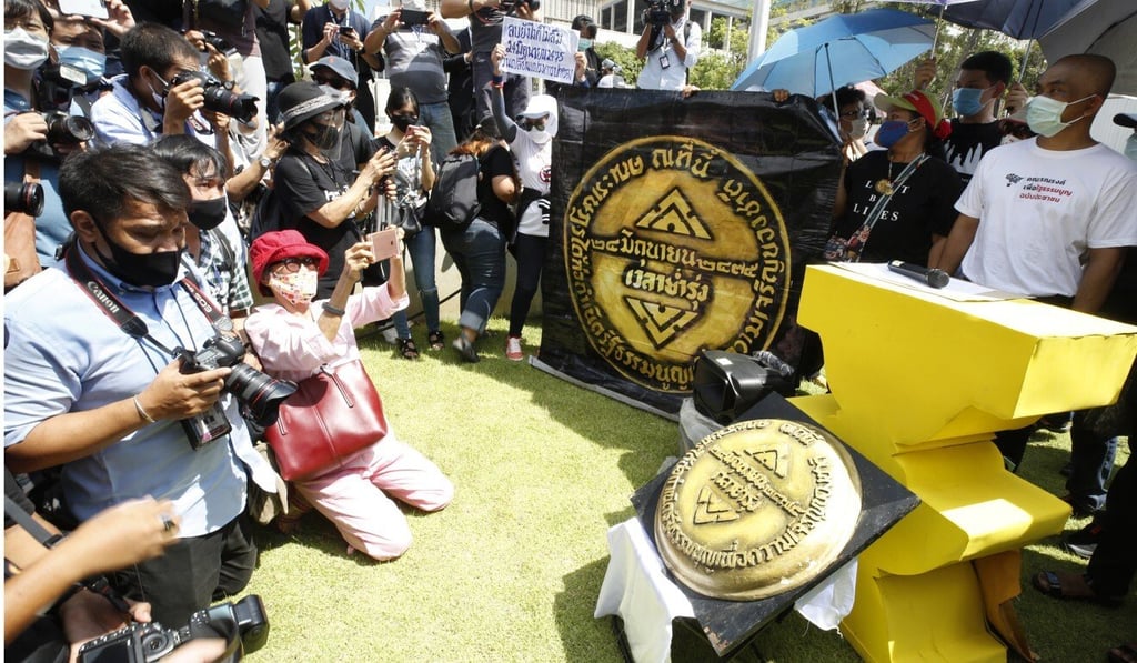 Thai pro-democracy activists display a mock-up of the missing 1932 Siamese Revolution plaque as they mark the anniversary of the revolt. Photo: EPA-EFE