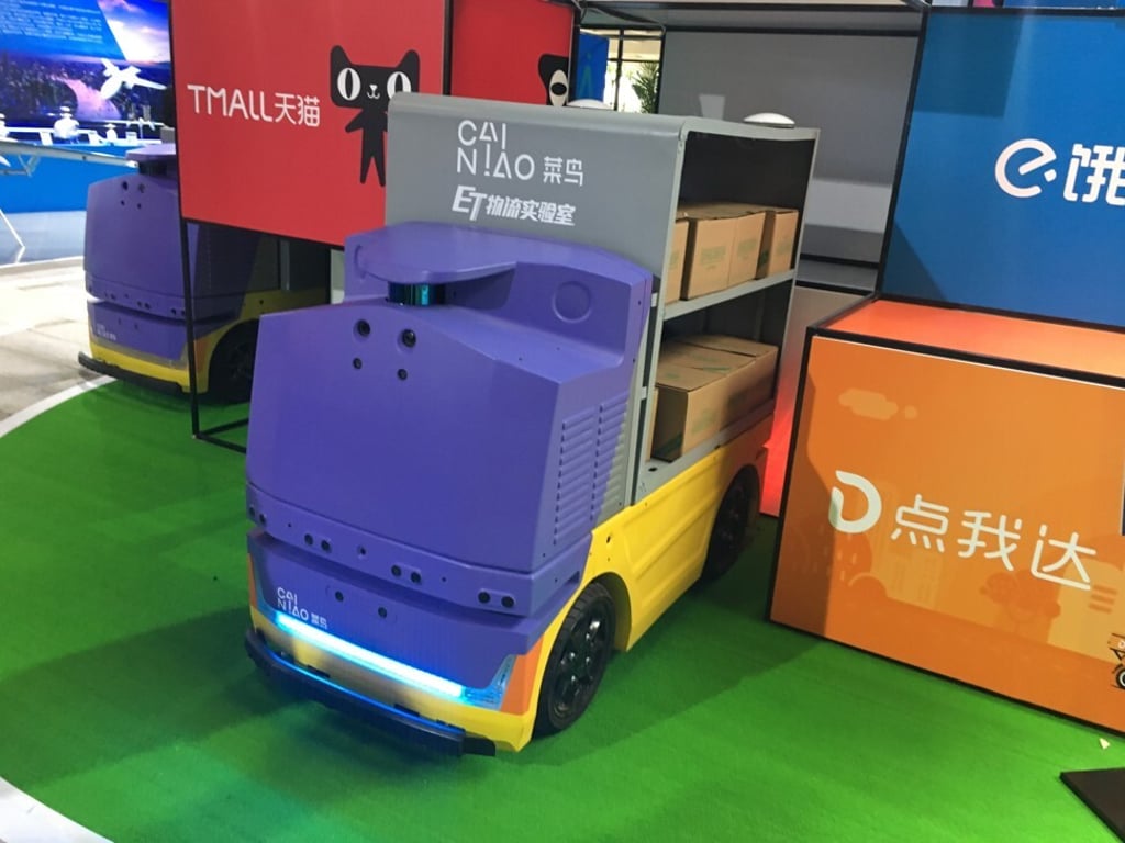 A Cainiao robotic arm puts boxes on sorting robots. Photo: Zen Soo A Cainiao robotic arm puts boxes on sorting robots. Photo: Zen Soo