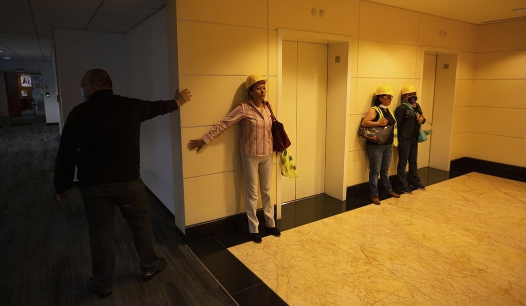 People brace themselves against a wall in Mexico City during an earthquake on Tuesday. Photo: AP People brace themselves against a wall in Mexico City during an earthquake on Tuesday. Photo: AP