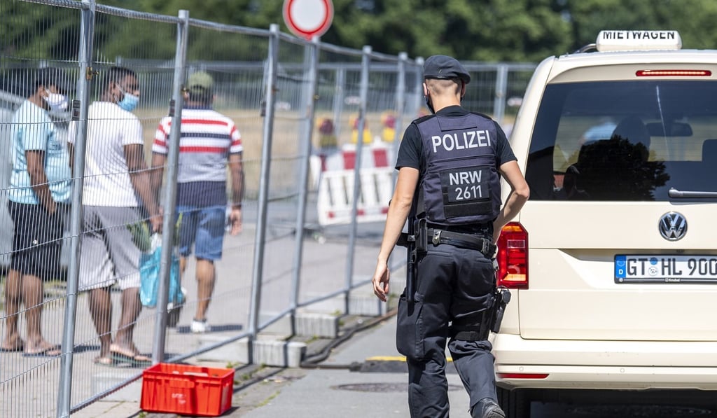 A police officer walks next to apartment buildings under lockdown following a coronavirus outbreak in Germany. Photo: DPA