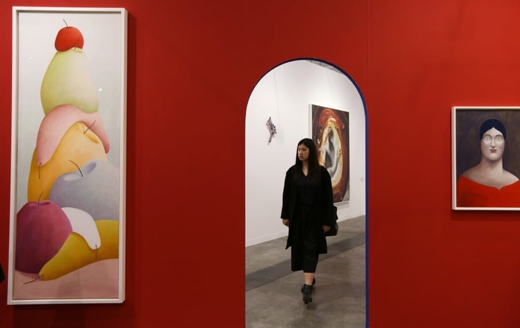 A woman enjoys works by Swiss-born artist Nicolas Party, photographed during the Art Basel media reception at the Hong Kong Convention and Exhibition Centre in Wan Chai. 27MAR18 SCMP / Xiaomei Chen