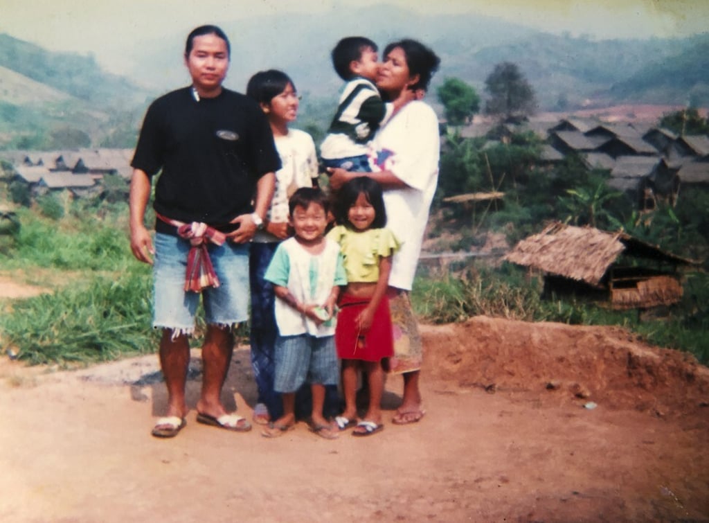 Hnin (second left) looks at her mother (far right) as she holds a child at a refugee camp in Thailand after escaping from Myanmar, in 2000. Photo: Courtesy Hnin Yee Htun