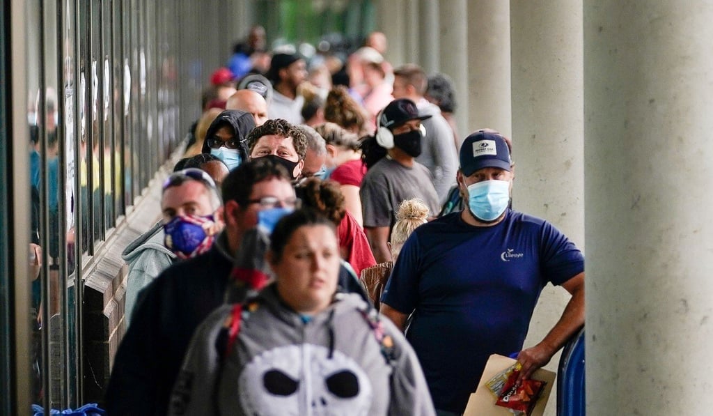 Hundreds of people line up outside a Kentucky Career Centre looking for assistance with their unemployment claim in Frankfort, Kentucky, on June 18. US unemployment numbers showed an unexpectedly large drop in May. Photo: Reuters