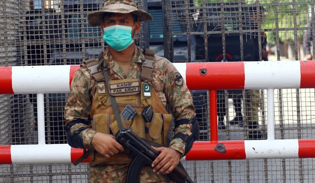 A Pakistani soldier stands guard next to bullet holes on barricade a day after terrorists attacked Pakistan Stock Exchange. Photo: EPA-EFE