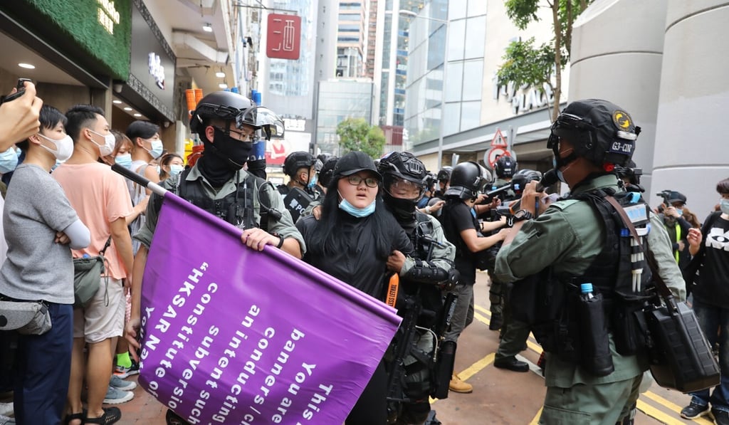 A woman is arrested after allegedly waving a flag advocating Hong Kong independence. Photo: Dickson Lee A woman is arrested after allegedly waving a flag advocating Hong Kong independence. Photo: Dickson Lee