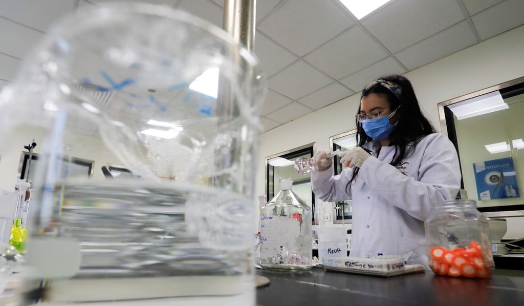 A pharmacist works on materials for research into Covid-19 treatment remdesivir in Cairo, Egypt in June. Photo: Reuters