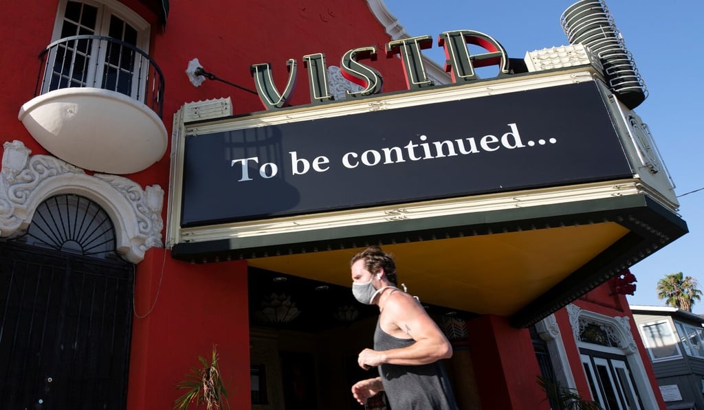 A jogger wearing a face mask passes the Vista theatre in Los Angeles on Monday. Photo: Reuters A jogger wearing a face mask passes the Vista theatre in Los Angeles on Monday. Photo: Reuters
