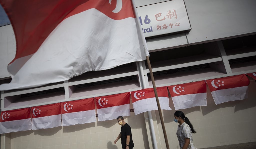 People walk outside a food centre during a campaign event ahead of Singapore’s election. Photo: EPA People walk outside a food centre during a campaign event ahead of Singapore’s election. Photo: EPA