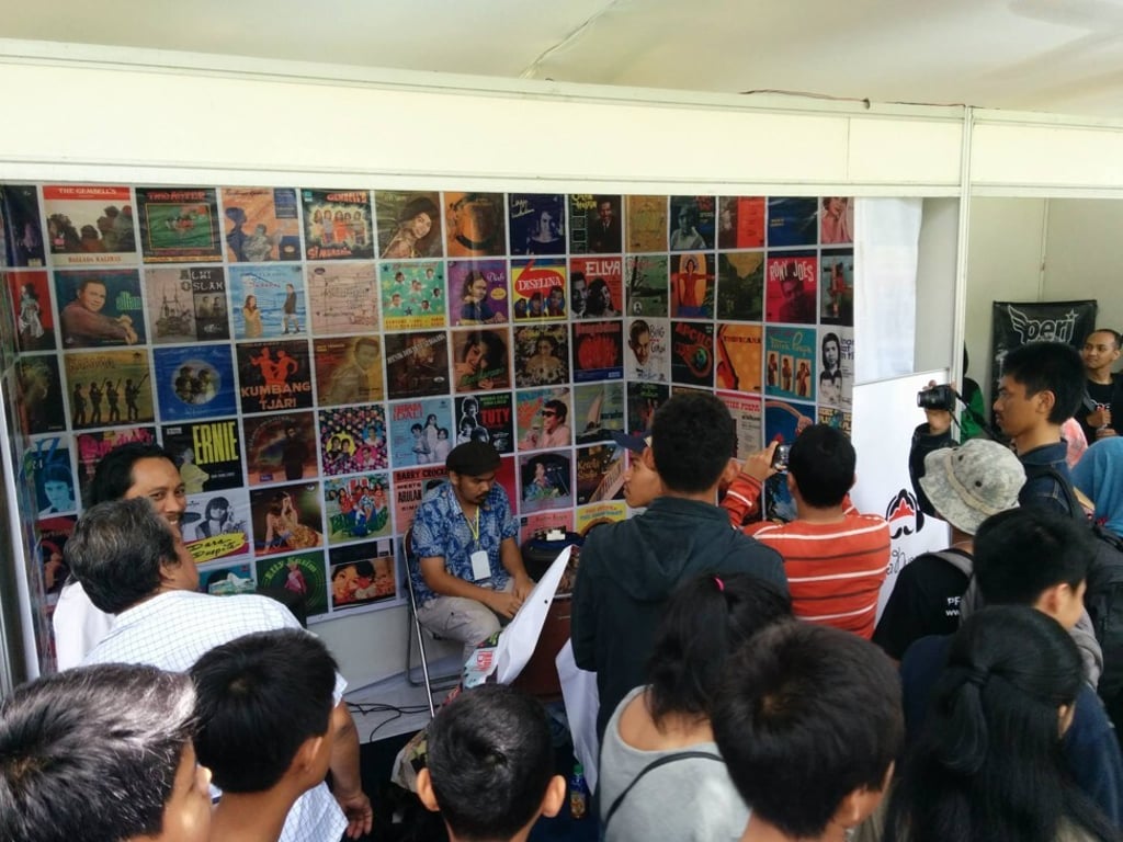 David Tarigan (centre, seated) at an Irama Nusantara exhibit in the Indonesian city of Bandung in 2014. Photo: Irama Nusantara
