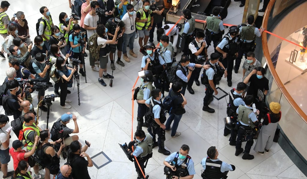 Hong Kong media members document the scene as police officers cordon off an area and check the ID cards of anti-government protesters in Central. Photo: Dickson Lee