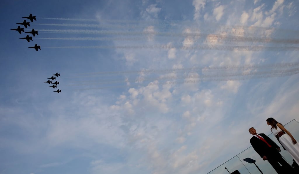 US President Donald Trump and first lady Melania Trump watch a US military aircraft flyover. Photo: Reuters