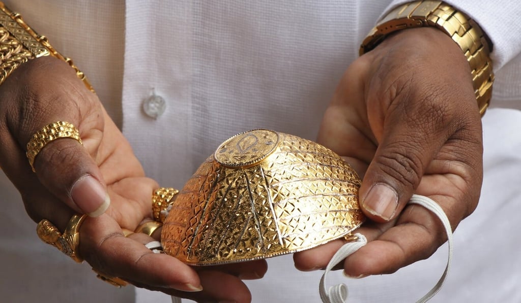 Shankar Kurhade shows off his face mask. Photo: Reuters