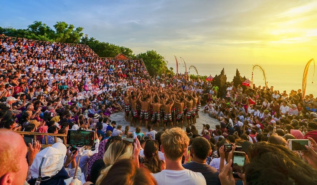 Tourists watch a traditional Balinese kecak dance at Uluwatu Temple. Photo: Shutterstock