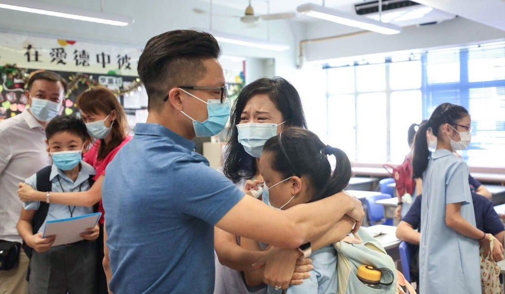 Ellie Wong, her mother Karen Chue, and father Jeff Wong, share a hug after learning Ellie will be attending True Light Girls' College. Photo: Xiaomei Chen