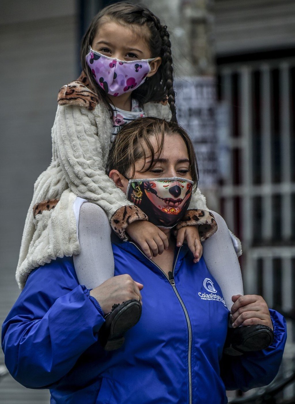 A woman and a girl wear face masks as a preventive measure against the spread of the coronavirus in Bogota, Colombia. Photo: AFP