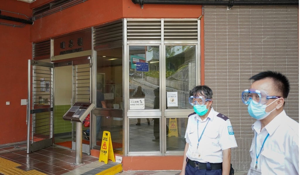 Security guards stand outside Ming Chuen House, Shui Chuen O Estate in Sha Tin. Photo: Felix Wong