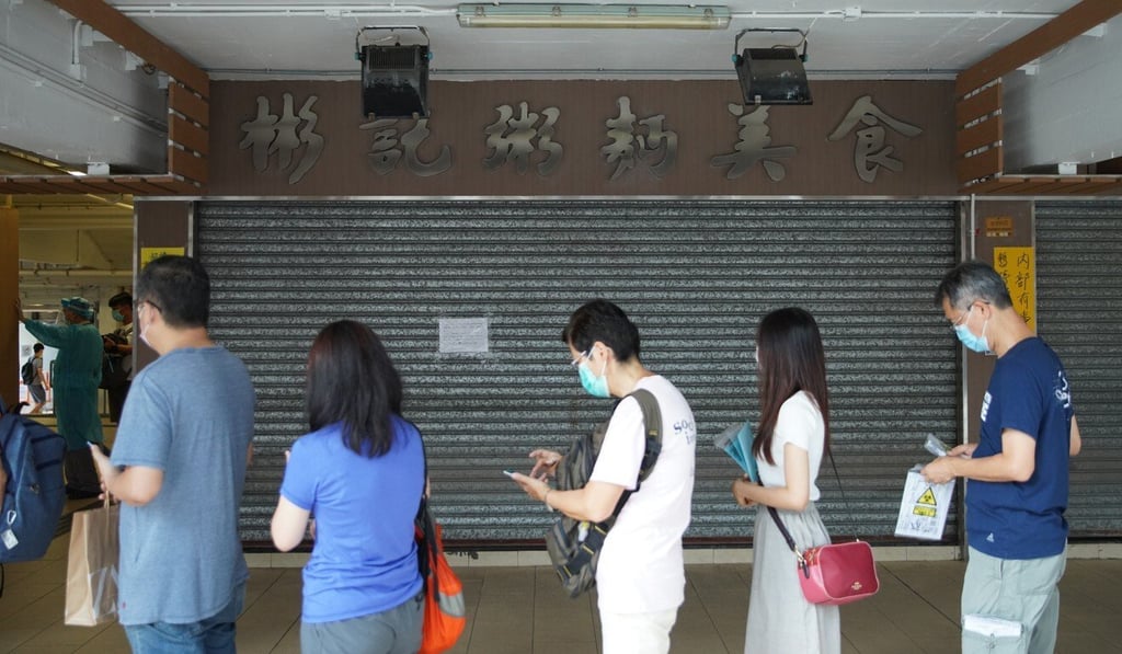 Hong Kong residents prepare to provide saliva samples at Ping Shek Estate, where a noodle shop cook tested positive for Covid-19. Photo: Winson Wong Hong Kong residents prepare to provide saliva samples at Ping Shek Estate, where a noodle shop cook tested positive for Covid-19. Photo: Winson Wong