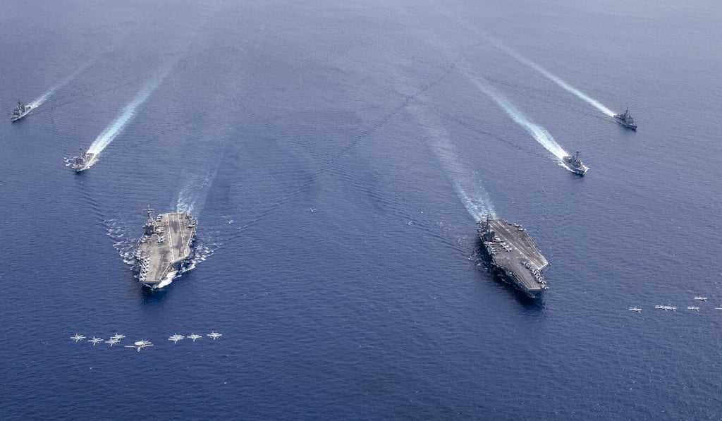 A handout photo made available by the US Navy shows aircraft flying in formation over the Nimitz Carrier Strike Force in the South China Sea on July 6. Photo: EPA / Handout