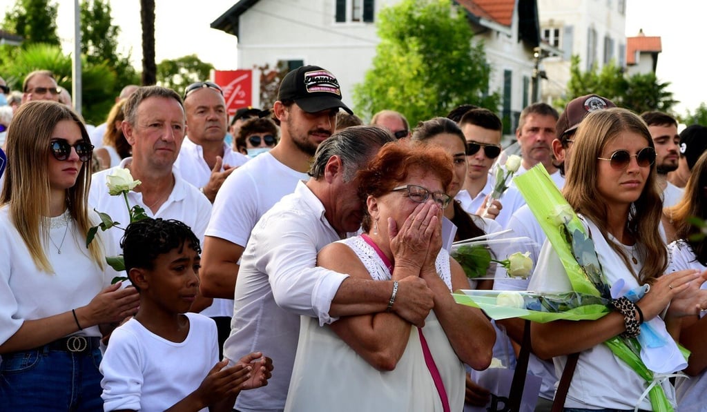 Parents of Veronique Monguillot, Philippe’s wife, react as they participate in a remembrance march for the bus drive. Photo: EPA Parents of Veronique Monguillot, Philippe’s wife, react as they participate in a remembrance march for the bus drive. Photo: EPA