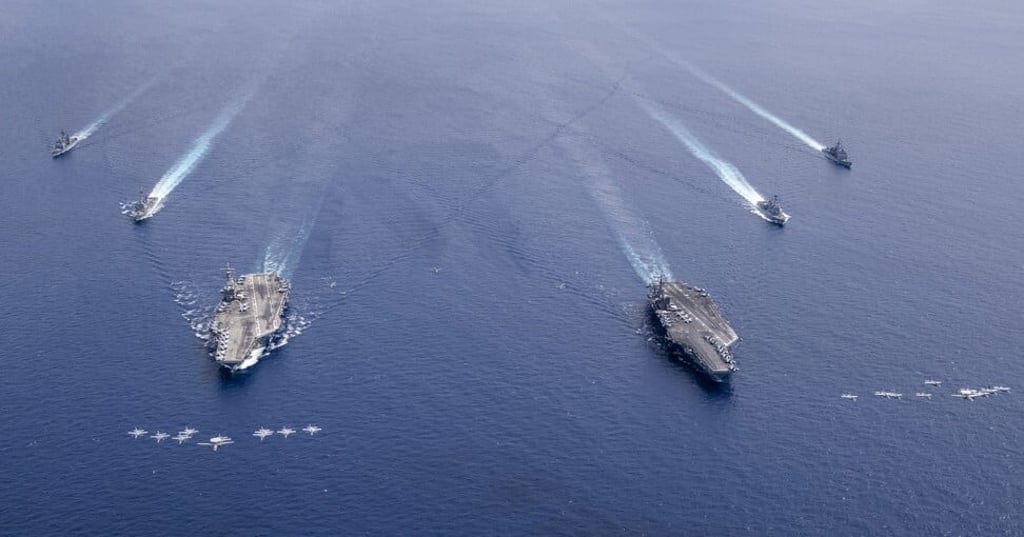 Aircraft from Carrier Air Wings 5 and 17 fly in formation over the Nimitz Carrier Strike Force, in the South China Sea on July 6. Photo: EPA-EFE