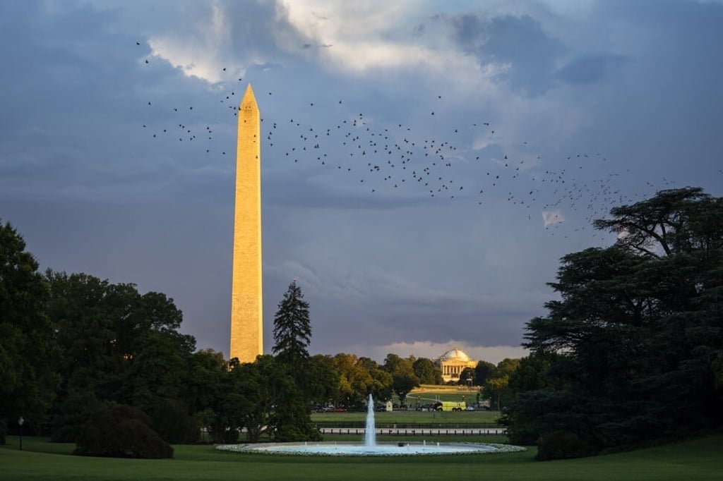 The Washington Monument looms over the Jefferson Memorial at dusk in Washington, DC. Photo: EPA-EFE