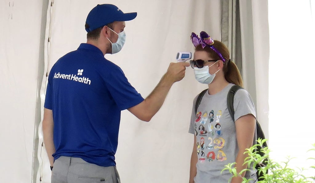 A woman has her temperature taken before entering the Magic Kingdom at Walt Disney World. Photo: AP