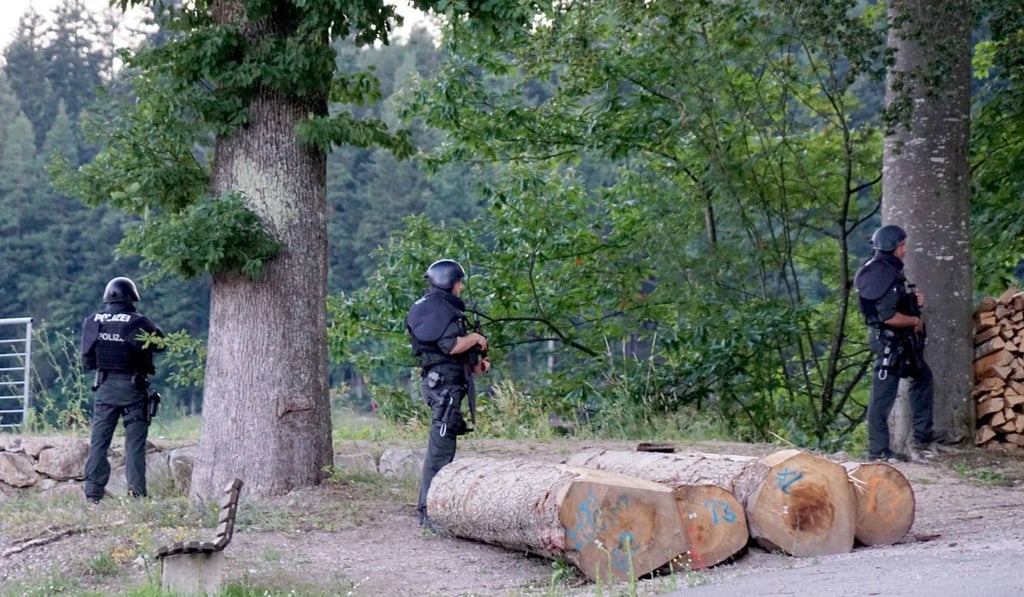 Police officers at a wooded area on a road near Oppenau, Germany. Photo: dpa Police officers at a wooded area on a road near Oppenau, Germany. Photo: dpa