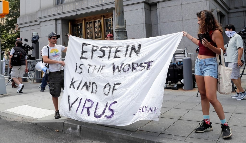 Protesters hold a banner that reads “Epstein is the worst kind of virus” outside Manhattan Federal Court on Tuesday. Photo: Reuters Protesters hold a banner that reads “Epstein is the worst kind of virus” outside Manhattan Federal Court on Tuesday. Photo: Reuters