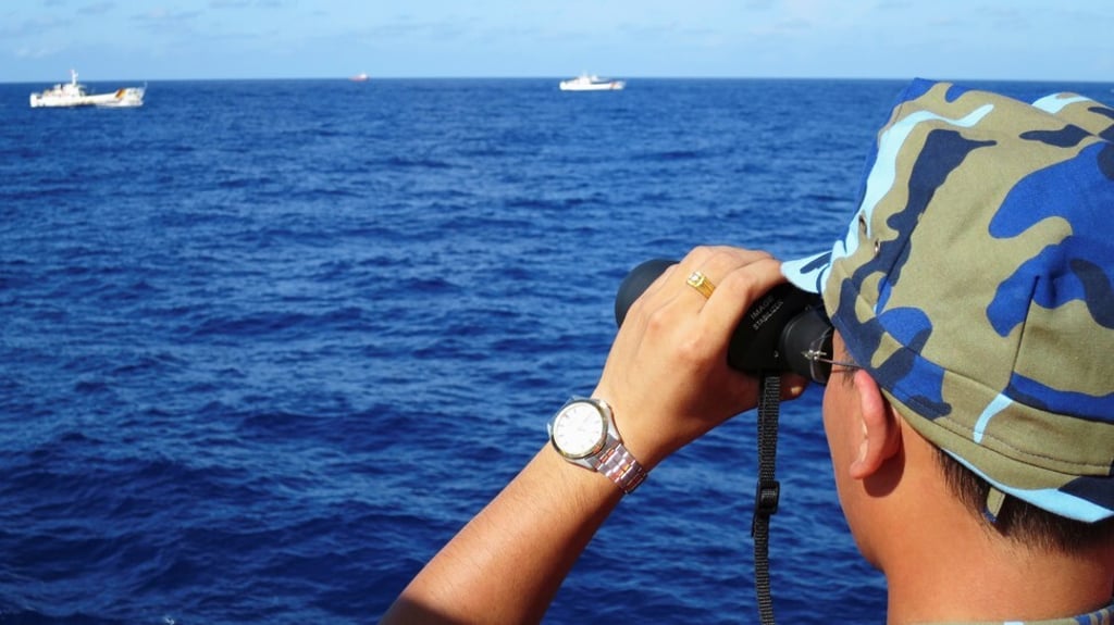 A crewman from the Vietnamese coastguard ship looks out at sea as Chinese vessels tail Vietnamese ships that came close to a Chinese oil rig in the South China Sea on July 15, 2014. File photo: Reuters
