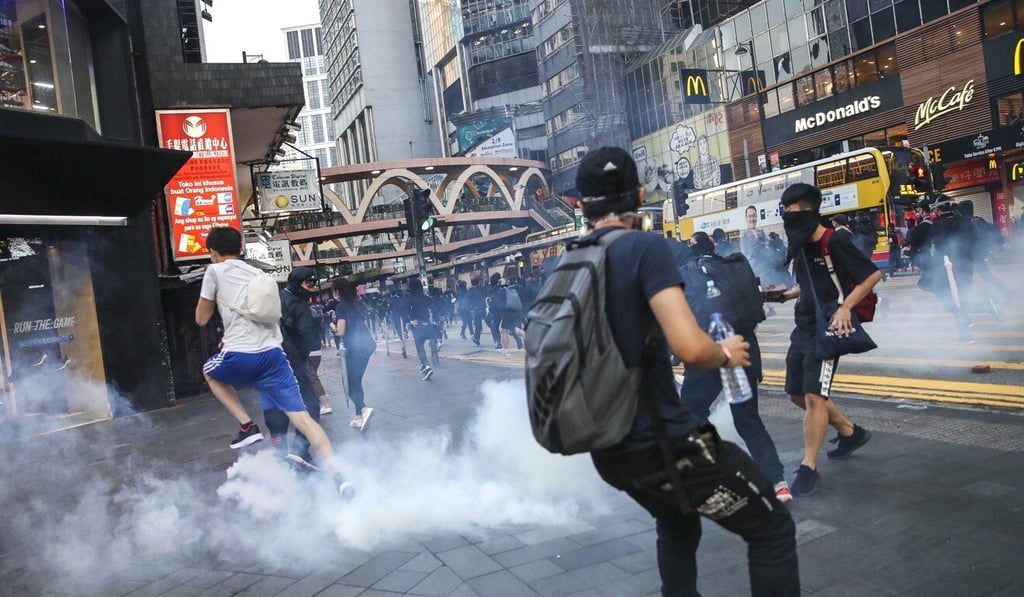 Anti-government protesters react to tear gas fired by riot police in Causeway Bay last November. Photo: Winson Wong