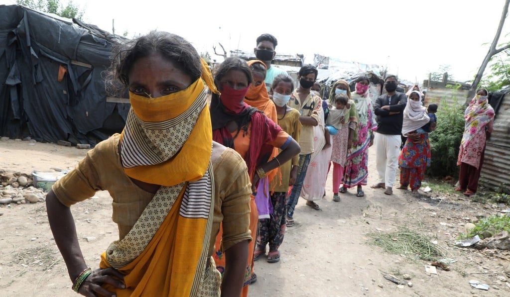 People wait for Covid-19 testing in a slum area in Jammu, India, on Thursday. Photo: EPA People wait for Covid-19 testing in a slum area in Jammu, India, on Thursday. Photo: EPA